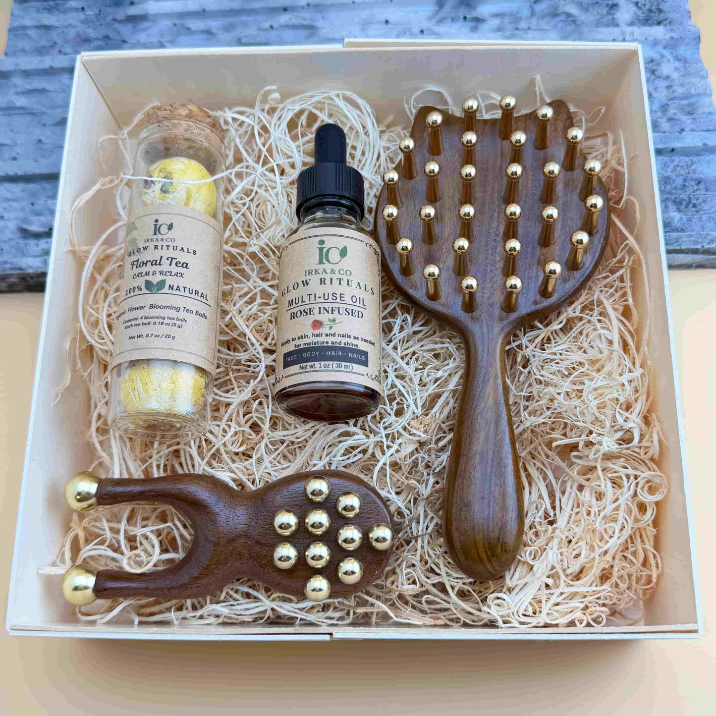 Relaxation gift for mom with massage tools, botanical oil, and calming blooming tea ritual
