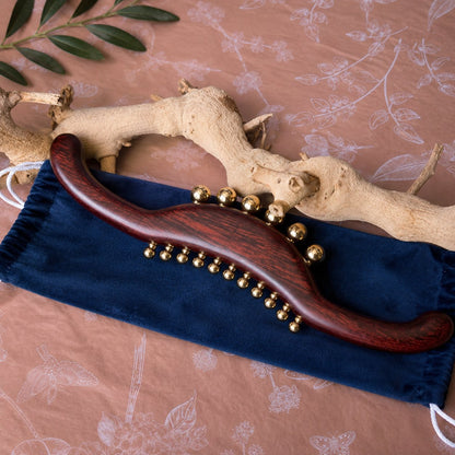 Wood and brass body massager styled for a back, neck and leg tension relief ritual