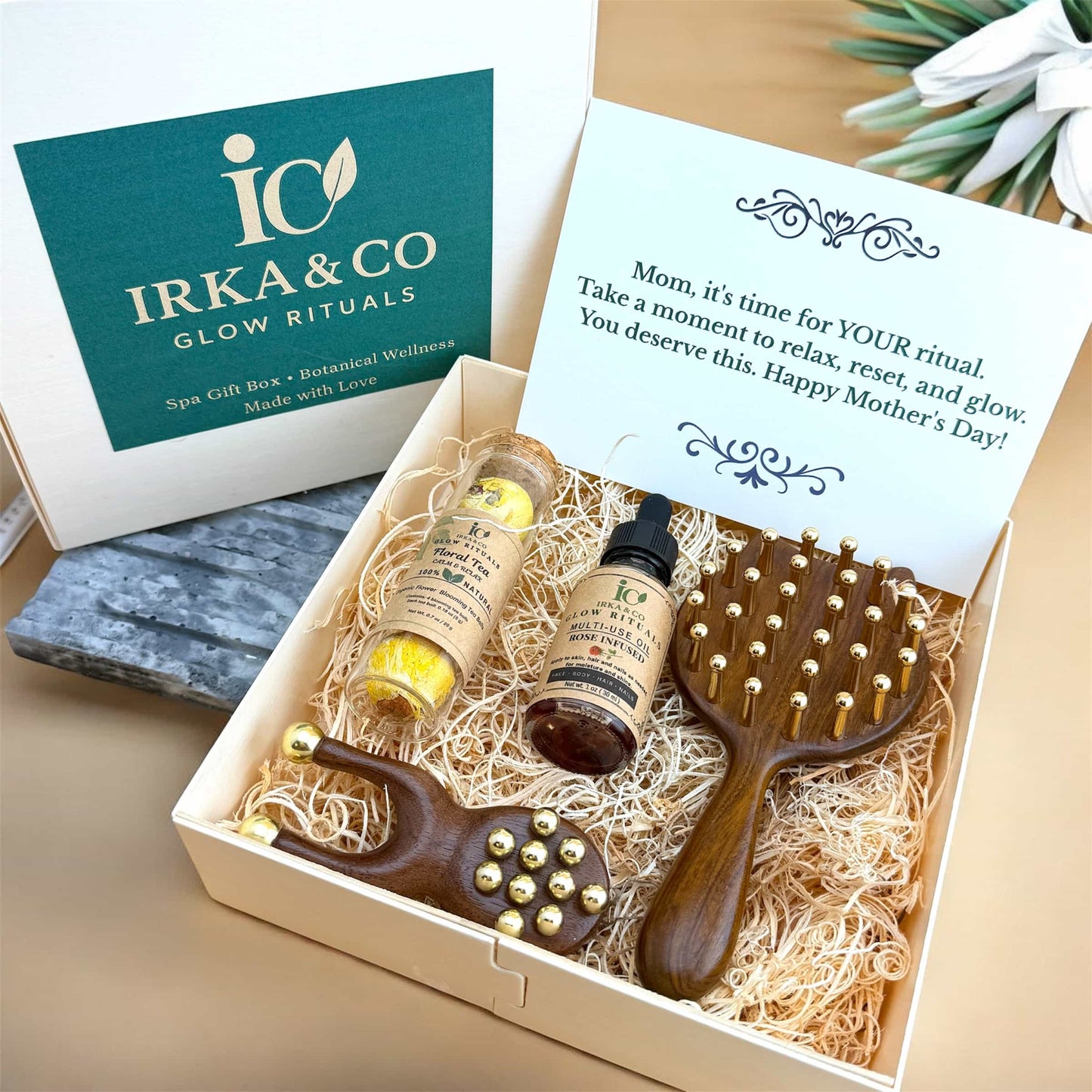 Mother’s Day wellness gift box with copper massage tools, botanical oil, and blooming tea set
