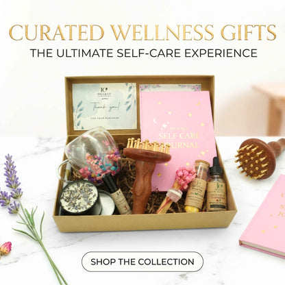 Curated Irka & Co wellness gift box with self-care journal, gua sha tool, facial oil, and dried botanicals, labeled "Curated Wellness Gifts, the Ultimate Self-Care Experience"