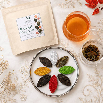 Irka & Co Autumn Tea Leaf Collection pouch with eight pressed tea leaves on a plate and a cup of brewed tea