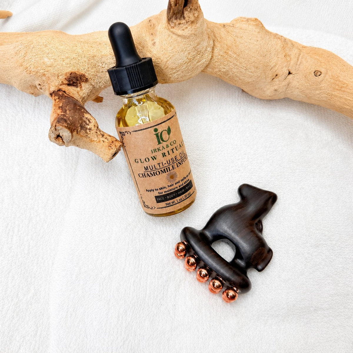 Little Horse facial massage tool next to a bottle of Irka & Co Glow Rituals Chamomile Infused Multi-Use Oil