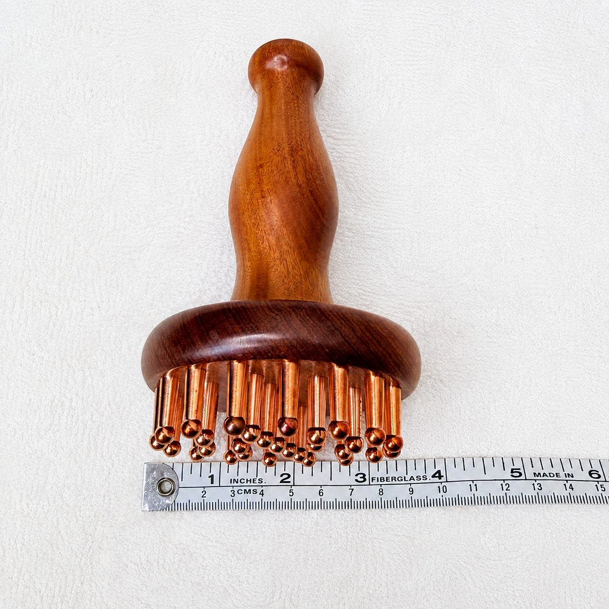 Copper & Rosewood Deep Tissue Massager measured with a ruler showing its 3.5 inch width