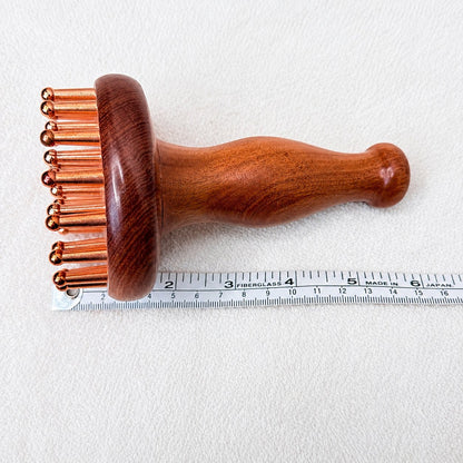 Copper & Rosewood Deep Tissue Massager measured lengthwise with a ruler showing its 6 inch length