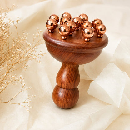 Copper and rosewood body contouring massage tool in a gift box, lifestyle flat lay
