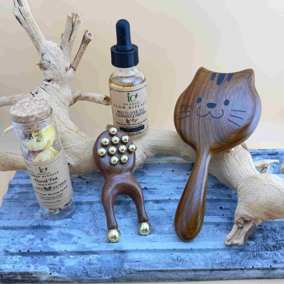 Brass massage tools laid out with botanical oil