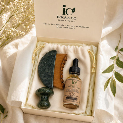 Jade Gua Sha & Scalp Ritual Set gift box with the IRKA & CO branded lid open, styled with eucalyptus and baby's breath