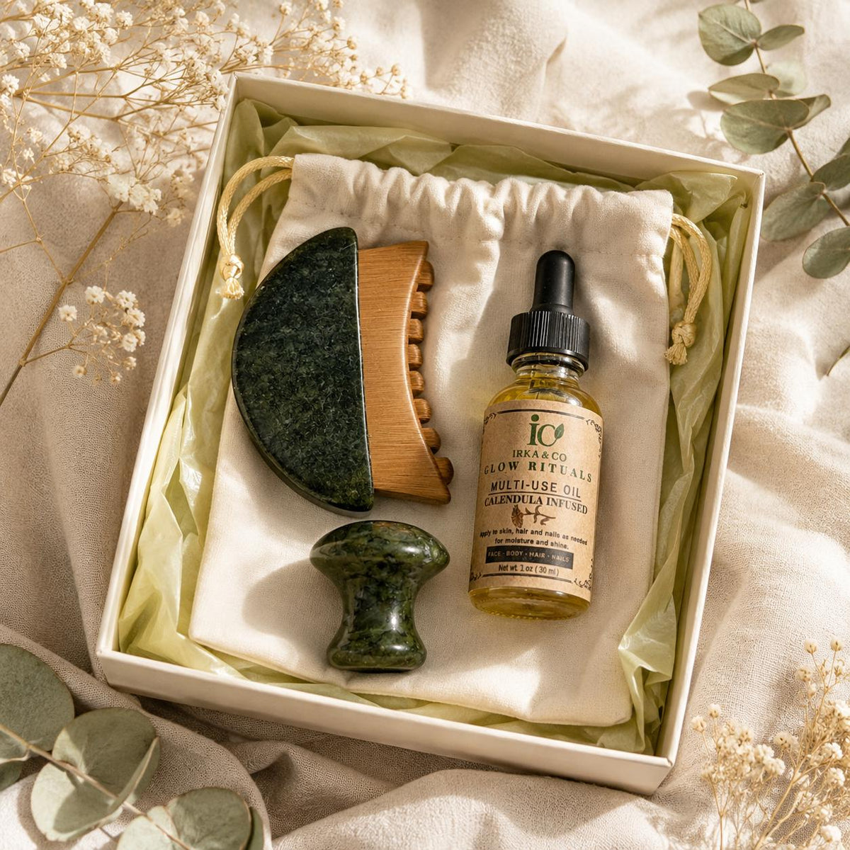 Close-up top-down view of the Jade Ritual Set inside its gift box, styled with eucalyptus and dried baby's breath