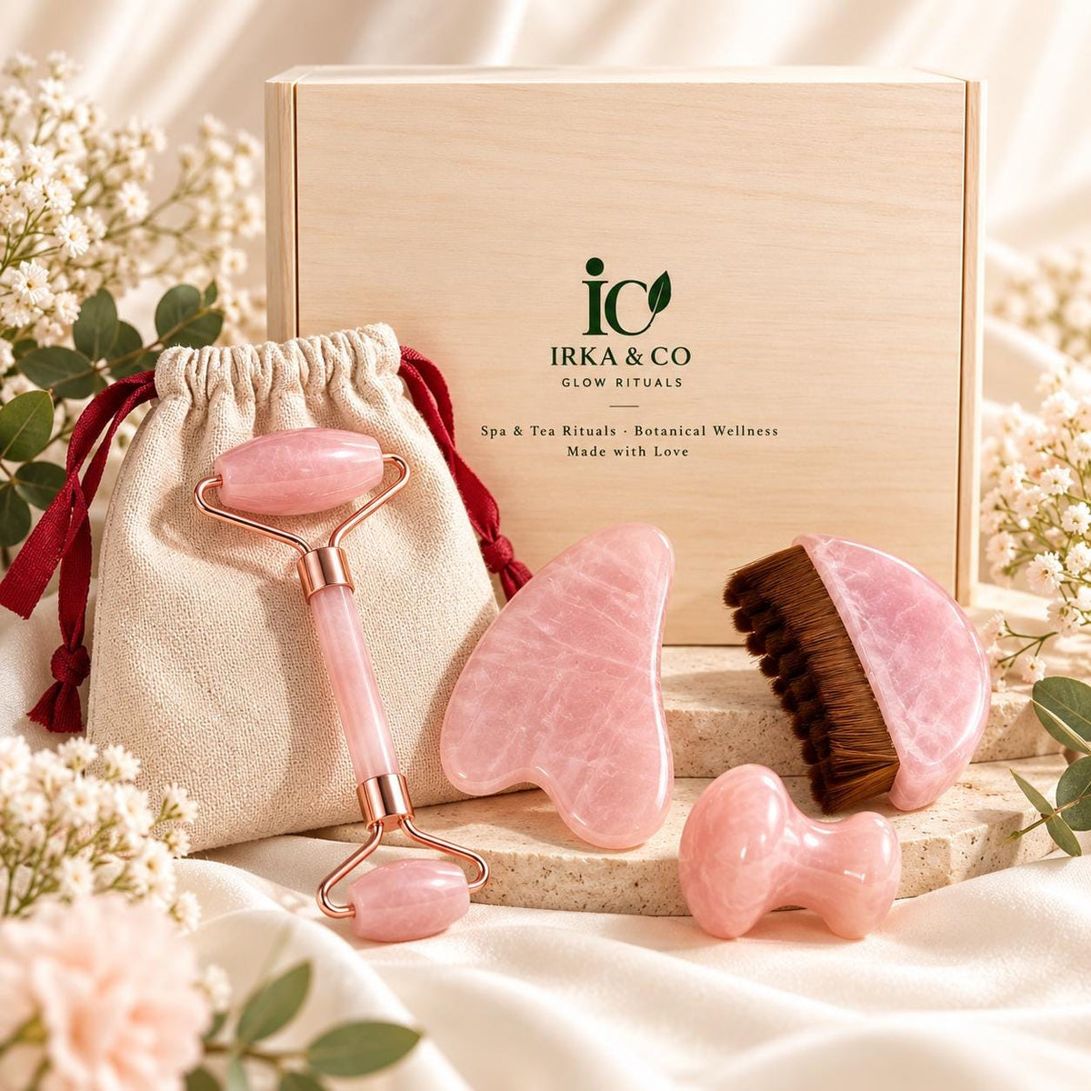 Rose quartz facial tools flatlay - roller, gua sha, brush and mushroom