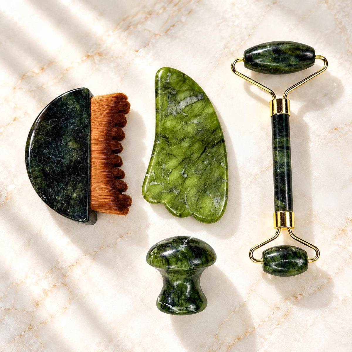 Jade facial tools flatlay - roller, gua sha, brush and mushroom