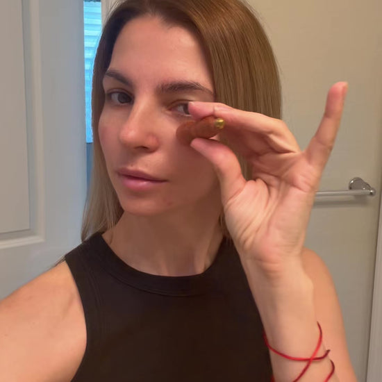 Video of a woman holding the Small Lotus Facial Roller up near her eye, demonstrating its compact size