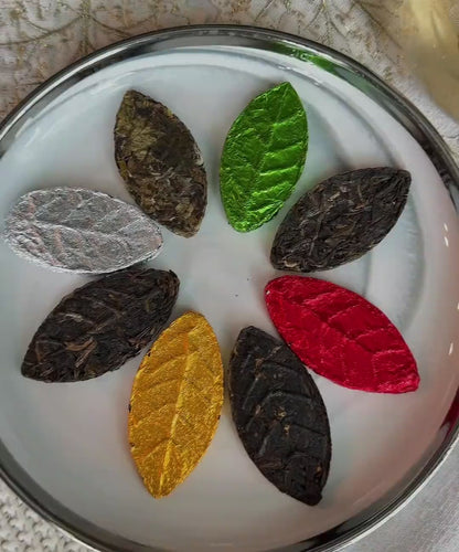 Pressed tea leaf slowly opening and steeping in a glass cup of hot water, turning it into amber autumn tea