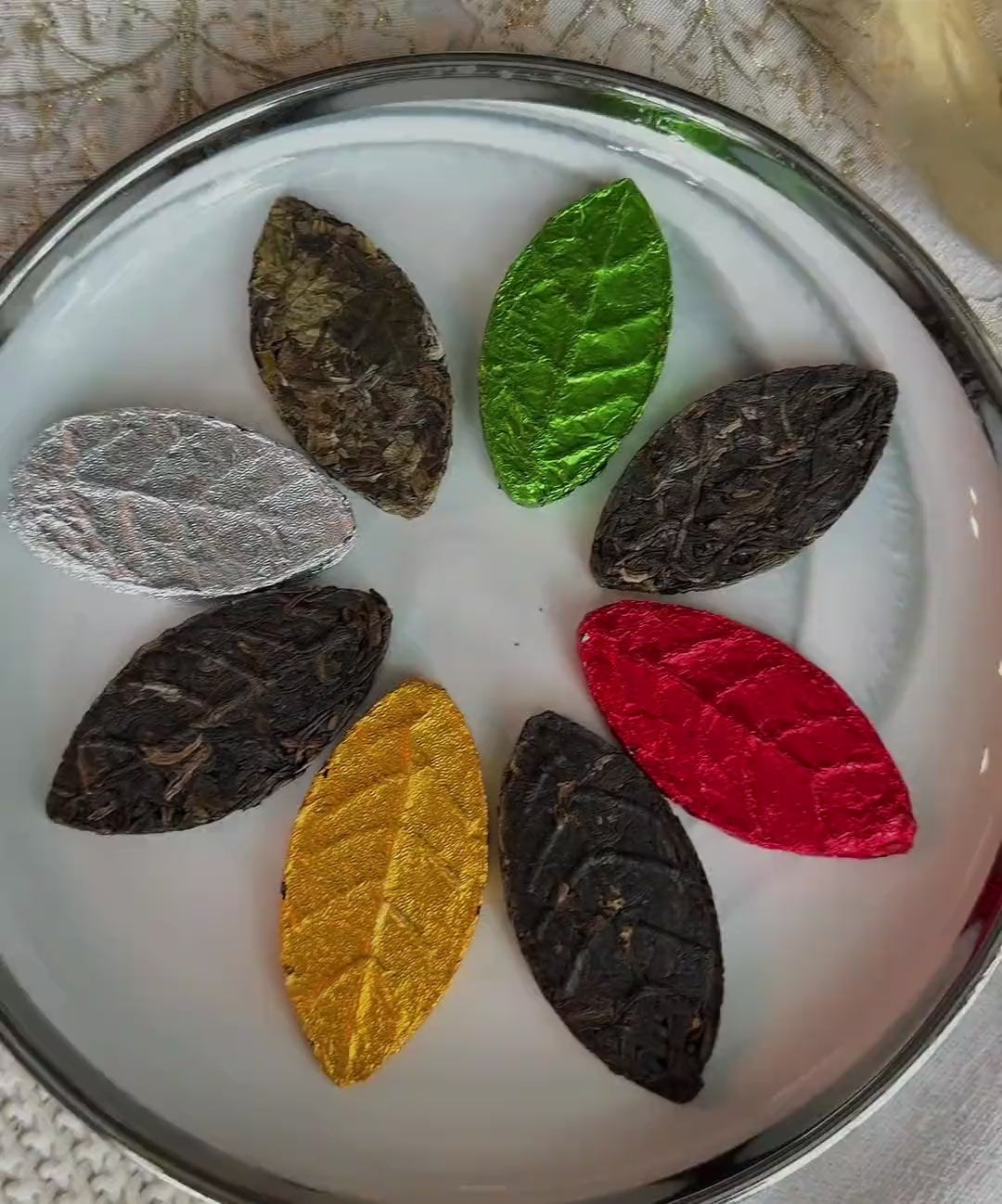 Pressed tea leaf slowly opening and steeping in a glass cup of hot water, turning it into amber autumn tea