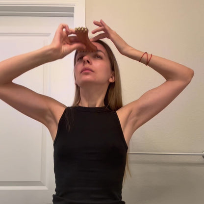 Video demonstration of how to hold and use the Jawline Sculpting & Lift Ritual Tool near the forehead and jaw