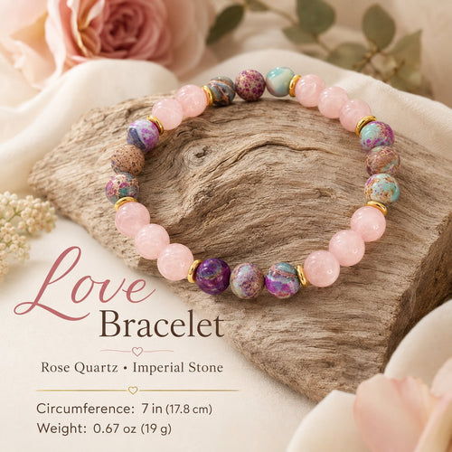 Rose Quartz & Imperial Stone Love Bracelet detail, resting on driftwood with pink roses